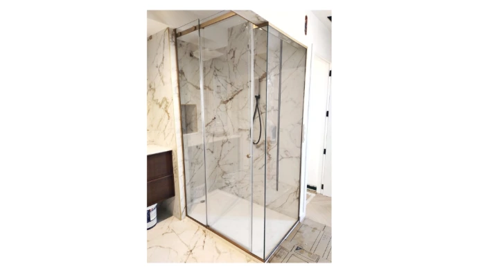 Mampara vidrio incoloro en vértice y perfiles oro mate